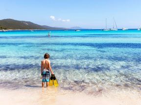 Dečak stoji na plaži Sakarun na Dugom otoku u Hrvatskoj