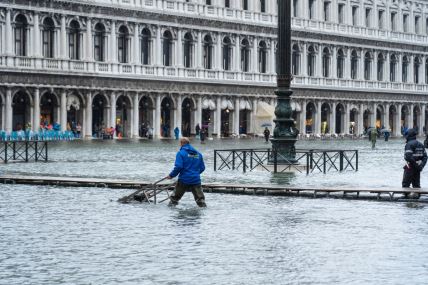 Čovek prolazi tokom poplava kroz Veneciju