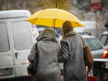 Žene šetaju Beogradom sa kišobranom dok veje sneg