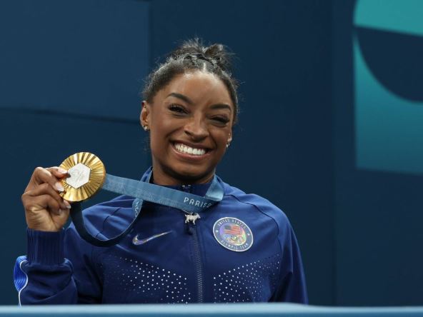 simon bajls drži zlatnu medalju koju je osvojila u gimnastici na olimpijskim igrama u parizu